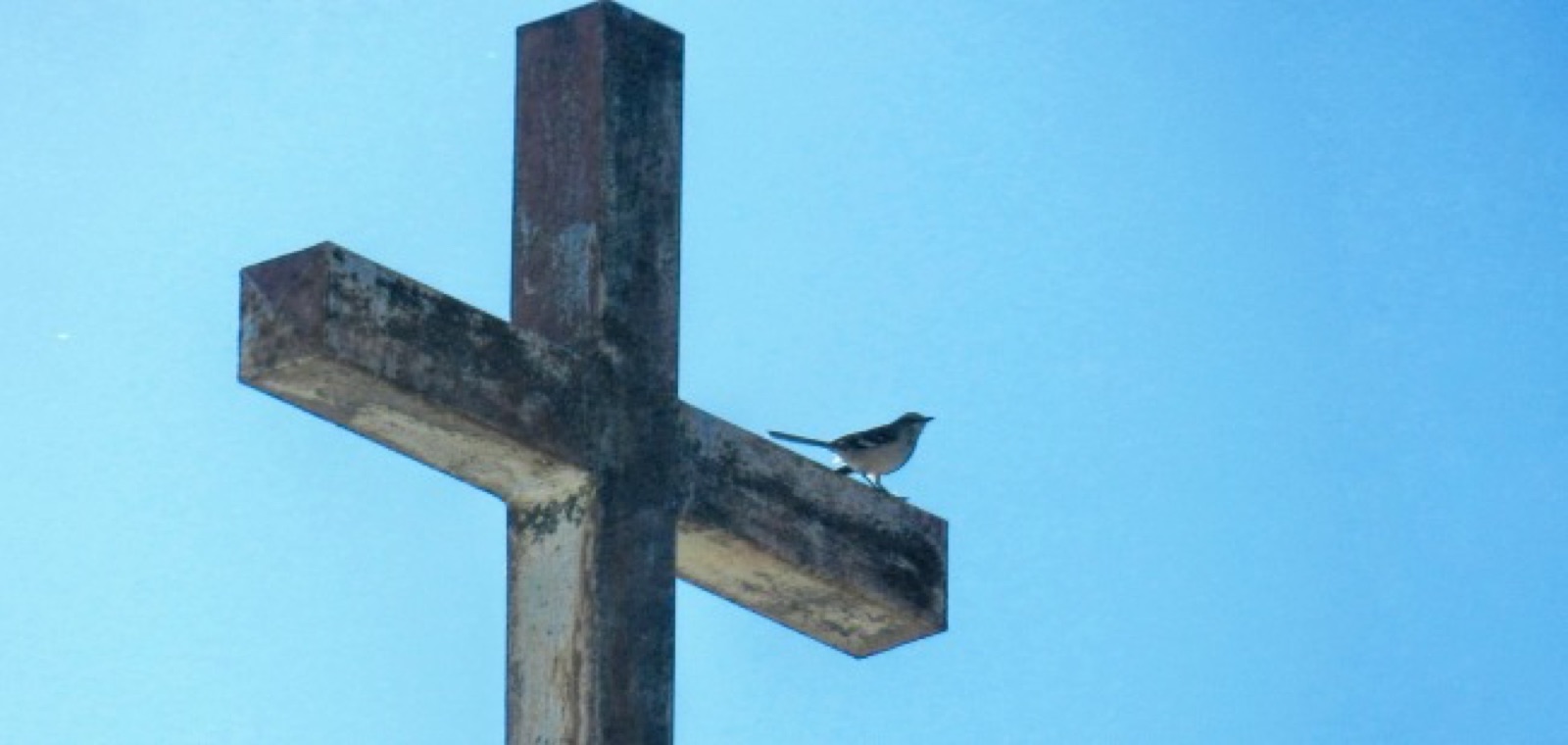 Wooden cross against a clear blue sky